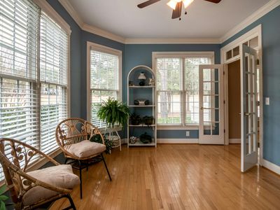 Sunlight streaming through blinds onto a wooden floor
